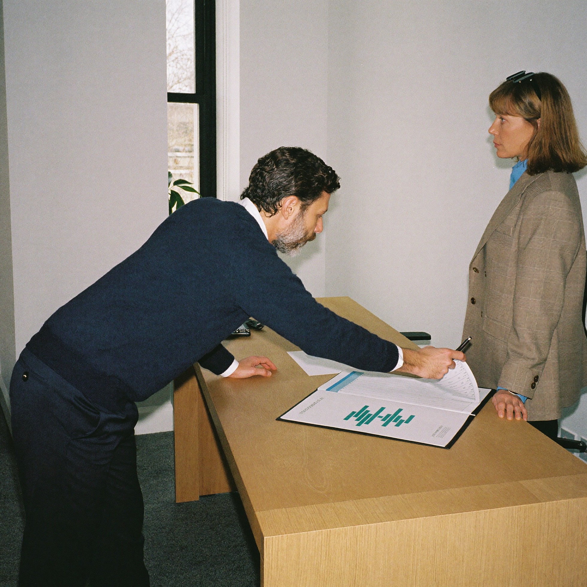 A controller presenting a monthly report to an administrator