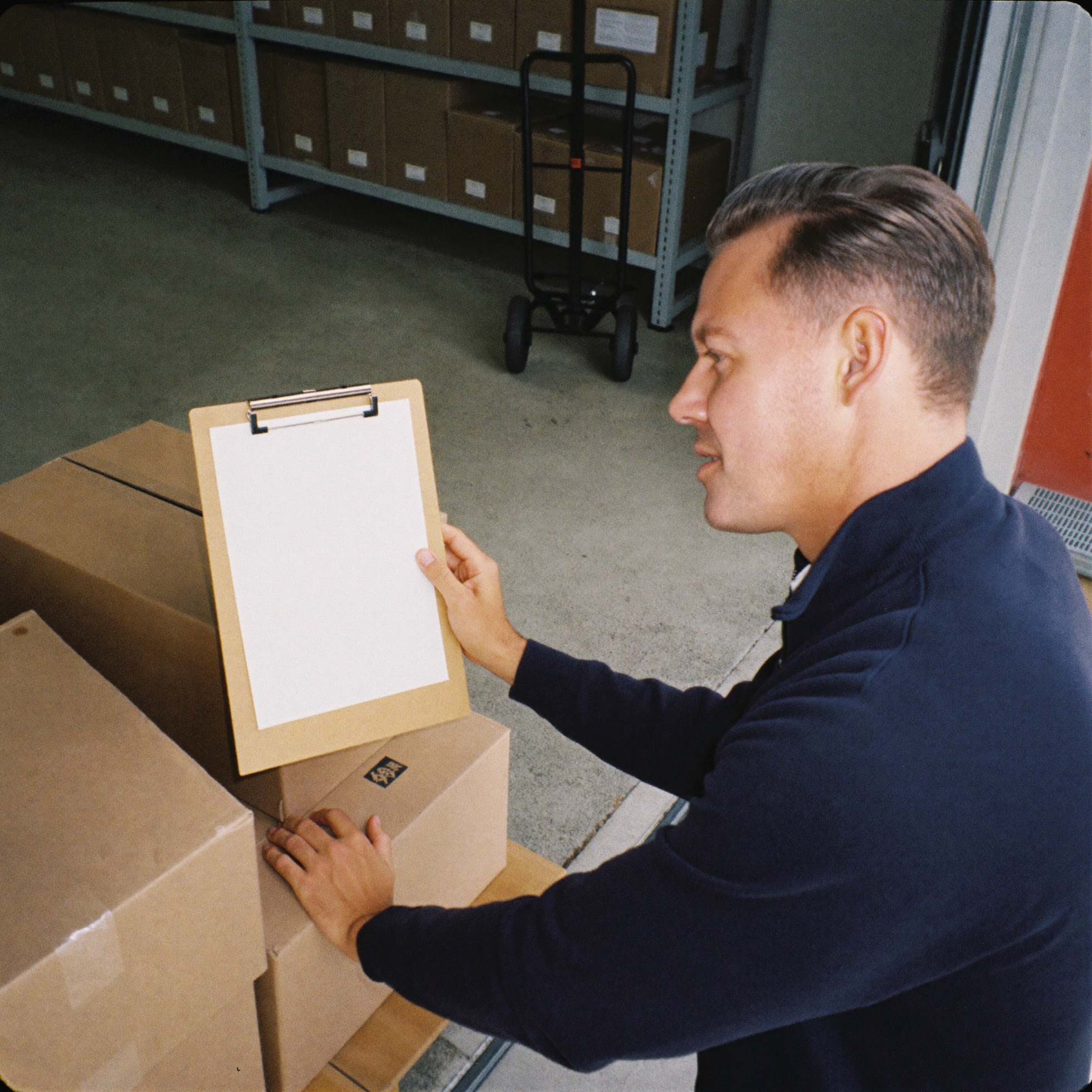 A purchasing manager checking a delivery in the receiving area